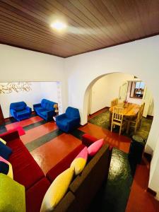 a living room with a couch and chairs and a table at Lodgepole Pine Resorts in Welimada