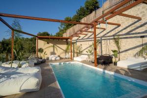 a swimming pool in a backyard with a pergola at Thomas Nice View Retreat in Argyroupolis