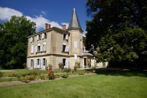 an old house with a tower on top of a yard at Chateau de Barral - Piscine privée in Hauterives