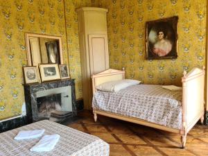 a bedroom with a bed and a portrait of a woman at Chateau de Barral - Piscine privée in Hauterives