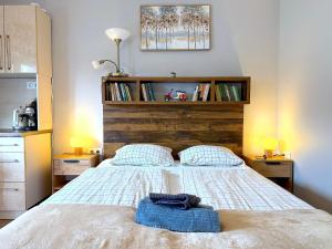 a bedroom with a bed with a blue towel on it at Paradiso Apartmanház in Gyula