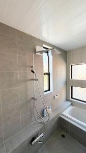 a shower in a bathroom with a tub and a sink at Villa Miura Beach -ヴィラ三浦海岸- in Miura +34 photos