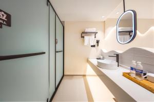 a bathroom with a sink and a mirror at Chongqing Nanqing·World Time Hotel in Chongqing +92 photos