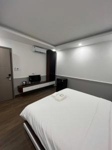 a bedroom with a white bed in a room at Cozy Corner Beach Hotel in Phú Quốc +45 photos