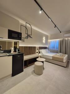 a bedroom with a bed and a kitchen with a sink at Shape Suites Athens in Athens