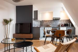 a kitchen and dining room with a table and chairs at Downtown by Max, Refuge in city center in Mulhouse