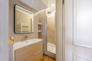a bathroom with a sink and a mirror at Downtown by Max, Refuge in city center in Mulhouse