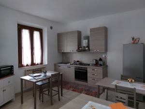 a kitchen with a table and a dining room at A Casa di Enrichetta in Montalcino