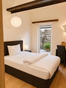 a large bed in a room with a window at S'Matt Bob in Feldkirch