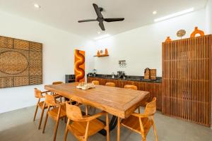 a dining room with a wooden table and chairs at Bingin Villas Luxury, Concierge and Security in Uluwatu +56 photos