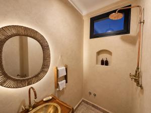 a bathroom with a sink and a mirror at Arya Imsouane in Imsouane