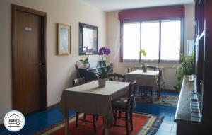 a dining room with two tables and a window at B&B Interno 8 in Rome