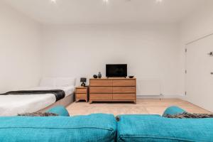 a living room with two beds and a tv at Sleeps 2 - Central - Studio - WiFi - Paid Parking in Maidstone