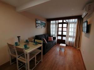 a living room with a couch and a table at Apartamentos Almenada in Llanes