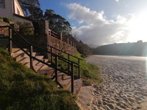 a fence on the side of a beach at Apartamentos Almenada in Llanes