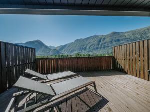 a chair on a deck with mountains in the background at Cozy Corner in Bovec