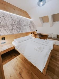 a large bed in a room with a large window at Cozy Corner in Bovec