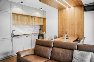 a living room with a couch and a kitchen at Cozy Corner in Bovec