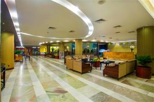 a lobby with couches and tables in a building at Rose View Hotel Sylhet in Sylhet +46 photos