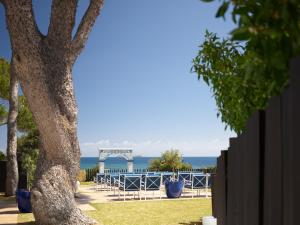 a view of the ocean from behind a fence at Hotel Mongibello Ibiza in Santa Eularia des Riu +136 photos