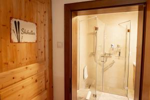 a bathroom with a shower with a glass door at Die Hornbacherin in Rottenmann +51 photos
