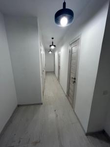 an empty hallway with white walls and a light fixture at Хостел Мануфактура in Kharkiv