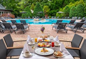 a table with food on it next to a pool at Lotus Therme Hotel & Spa in Hévíz