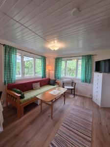 a living room with a couch and a table at Sonjas Camping & Stugor in Löttorp