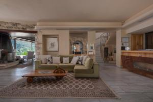 a living room with a couch and a table at Valeni Boutique Hotel & Spa in Portaria
