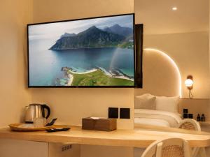 a living room with a tv hanging on a wall at CORRIDOR 2407 in Bangkok