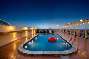 a pool on the deck of a cruise ship at night at Rose View Hotel Sylhet in Sylhet
