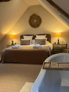 a bedroom with a bed and a bath tub at Chambres d'Aumont in Aumont +54 photos