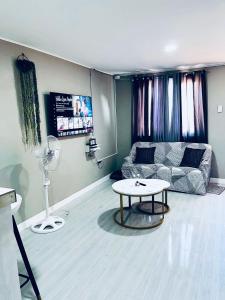 a living room with a couch and a table at Khaleejay Transient House in Calapan