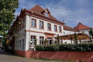 a white house with a brown roof at Wohnkultur - DSIGNIO Ladenburg Digital Hotel in Ladenburg