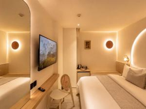 a hotel room with a bed and a chair at CORRIDOR 2407 in Bangkok +91 photos