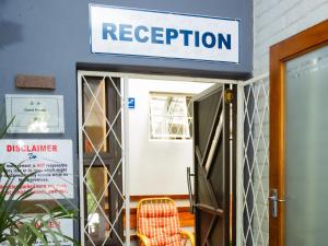 a sign that reads reception in front of a door at Zakumi Guesthouse in Kokstad