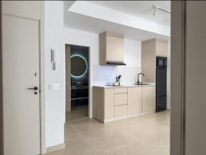 a kitchen with white cabinets and a black refrigerator at Elegante Apartamento de 1 Dormitorio en Nerja in Nerja +10 photos