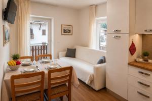 a living room with a table and a couch at Erica in Folgaria