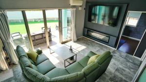a living room with a couch and a television at Sauna villa uchiumi in Uchiumi
