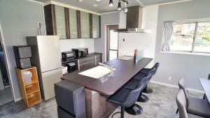 an office with a desk and chairs in a room at Sauna villa uchiumi in Uchiumi +10 photos
