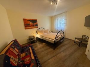 a bedroom with a bed and a couch in it at Hotel am Hindenburgplatz in Appenweier