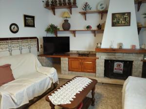 a living room with a couch and a fireplace at Casa Trini in Torremegía