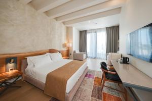 a hotel room with a bed and a desk at Chic Boutique Hotel Vlore in Vlorë