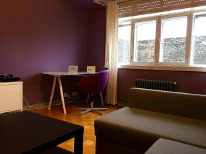 a room with a table and a chair and a window at Apartment Lugo Rooms in Lugo