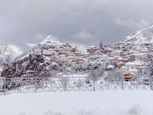 a snow covered city on top of a mountain at Borgo Izzo 2 in San Fele +5 photos
