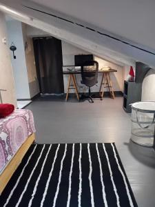 a room with a bed and a black and white rug at Monica & Rocco's House in Venaria Reale