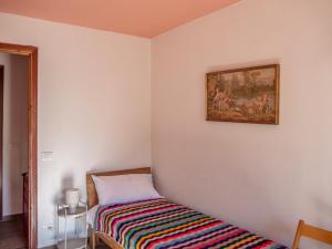a bedroom with a bed and a painting on the wall at Rosano 76 in Cabella Ligure