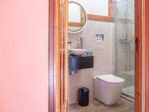 a bathroom with a toilet and a sink at Rosano 76 in Cabella Ligure