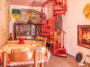 a dining room with a table and a fire place at Rosano 76 in Cabella Ligure