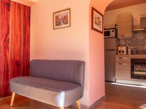 a gray chair sitting in a room with a kitchen at Rosano 76 in Cabella Ligure +74 photos